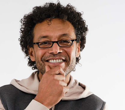 Male model wearing Mylo (Black) classic shape, slim reading glasses with black glossy frame.