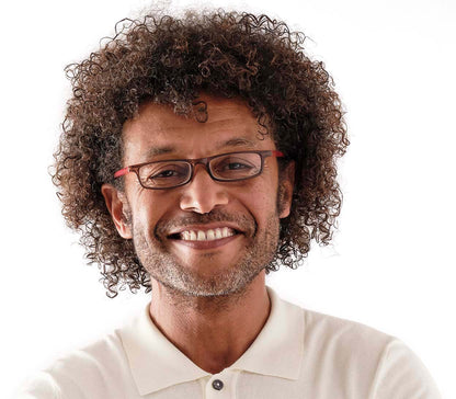 Male model wearing Jam (Orange) slender, rectangular unisex reading glasses with extra long arms to hang around your neck when not in use.