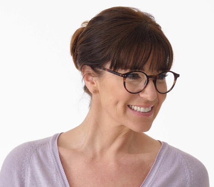 Female model wearing Oskar (Tortoiseshell) unisex reading glasses with large round lenses and soft touch deep tortoiseshell frames.