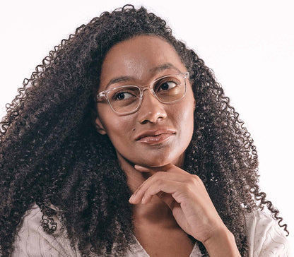 Female model wearing Artist Digital (Clear) unisex reading glasses with specialist blue light lenses. Clear frames and large oval lenses.