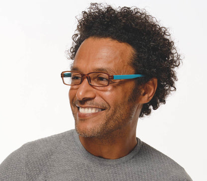 Male model wearing Hangover (Brown) unisex reading glasses with long arms for hanging around your neck. Turquoise arms and contrasting brown frames.