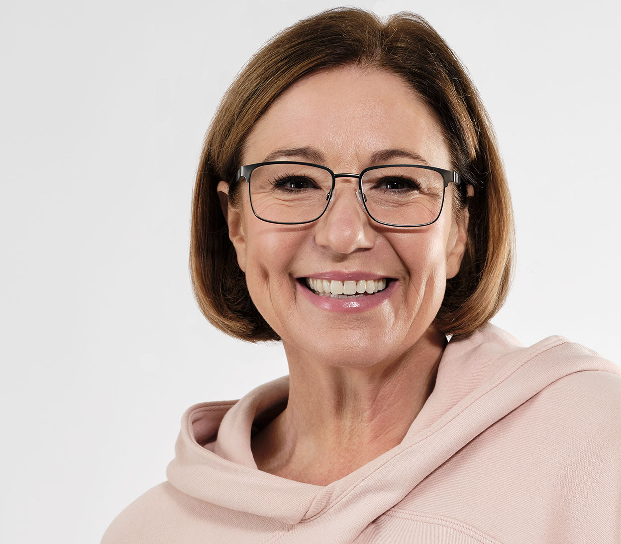 Female model wearing Seattle (Gunmetal) polished gunmetal reading glasses with large rectangular lenses and adjustable nose pads.