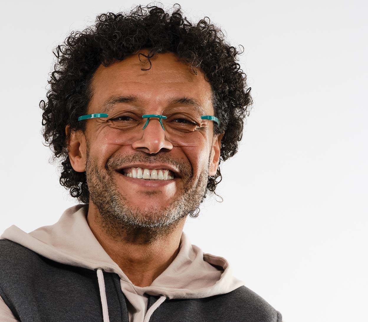 Male model wearing Jelli Max (Turquoise) square, rimless reading glasses with large lenses and turquoise details.