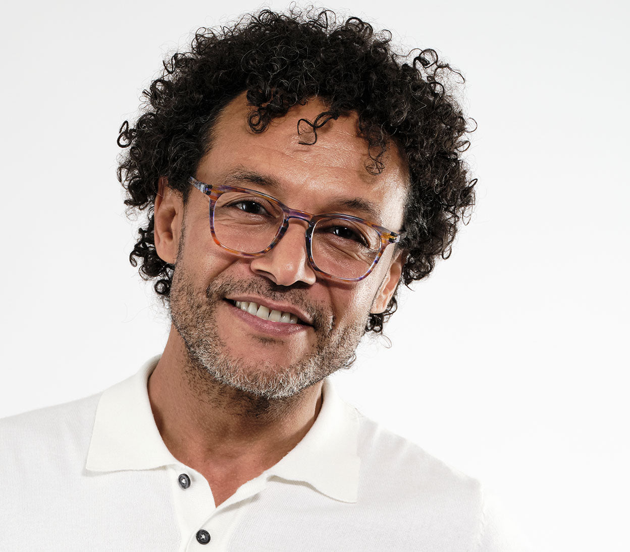 Male model wearing Scholar (Multi-coloured) retro unisex reading glasses with large oval shaped lenses, slender patterned multi-coloured frame.