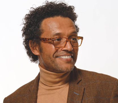 Male model wearing Harper (Tortoiseshell) retro, unisex reading glasses with oval lenses and a matt tortoiseshell frame.