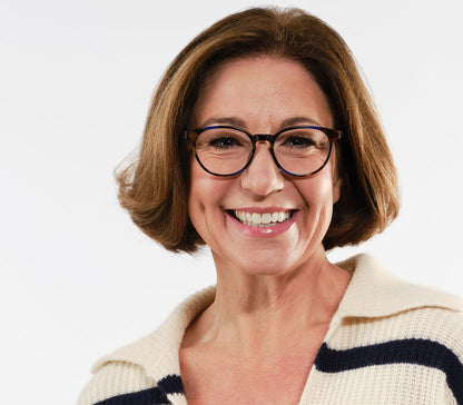 Female model wearing Marlow (Blue Tortoise) oval shaped reading glasses with a blue and brown tortoiseshell pattern and glossy finish.