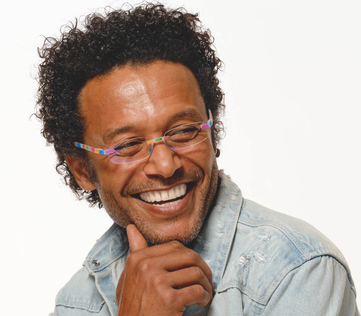 Male model wearing Jelli Digital (Multi-coloured) rimless, slim reading glasses with semi translucent, multicoloured arms and bridge.