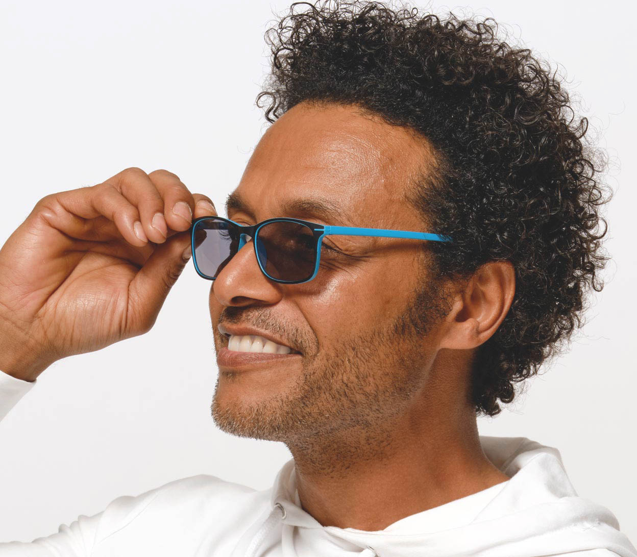 Male model wearing Esprit (Blue) sunglasses with two tone blue and black frames and temples. Classic shaped lenses with a smoke grey tint.